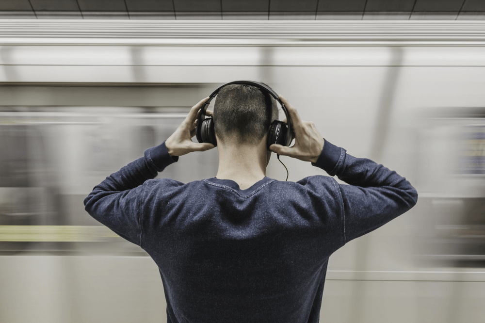 A man listening to music using headphones